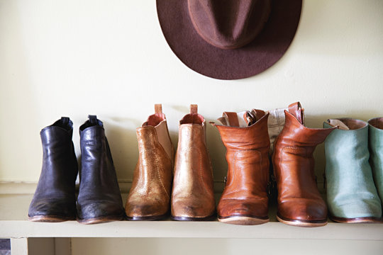 Boots and hats arranged on a shelf