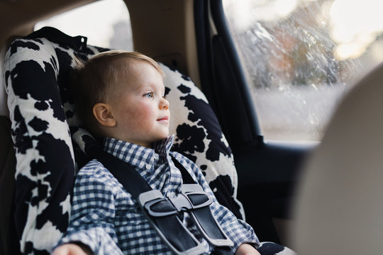 toddler riding in a car