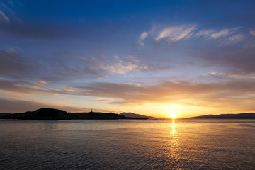 Sunset over Oban Bay and the entrance to Oban harbour. In the background is the island of Kerrera
