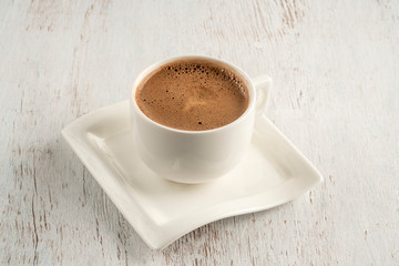 A cup of Turkish coffee on a wooden table