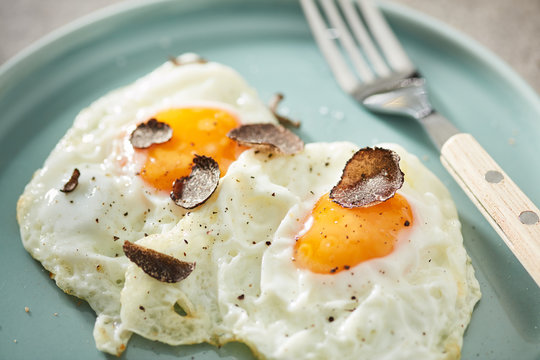 Closeup of delicious eggs seasoned with black truffle