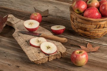 sliced apples on a wooden cutting board on a table