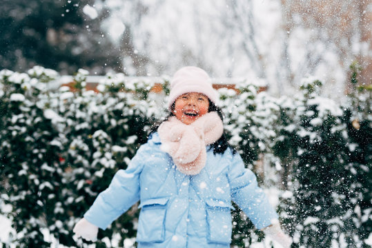 Cute girl playing in snow