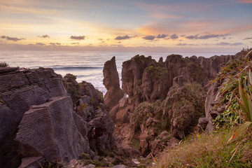 Pancake Rocks in Punakaiki, New Zealand, at sunset. Limestone formation overlooking the ocean.