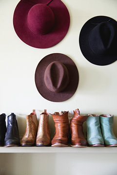 Boots and hats arranged on a shelf