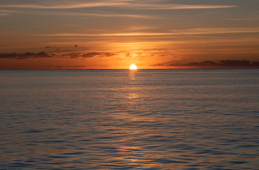 Beautiful sunrise which is golden and vibrant as the sun rises over the horizon of the mediterranean near Cala Millor Majorca. 