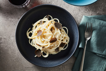 Composition of plate with pasta and black truffles