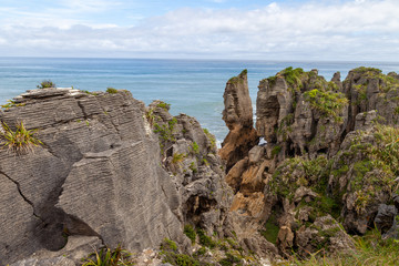 Fototapeta na wymiar Pancake Rocks in Punakaiki, New Zealand. Limestone formation overlooking the ocean in Paparoa National Park.