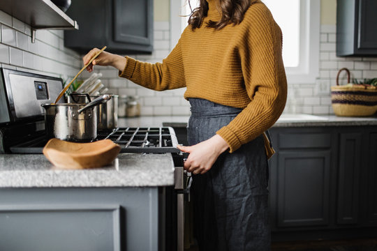 Woman Stiring Soup on the Stove