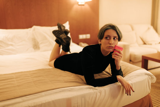 portrait of young androgyne woman on the bed