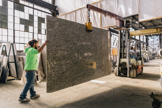 Man Walking with Stone Slab