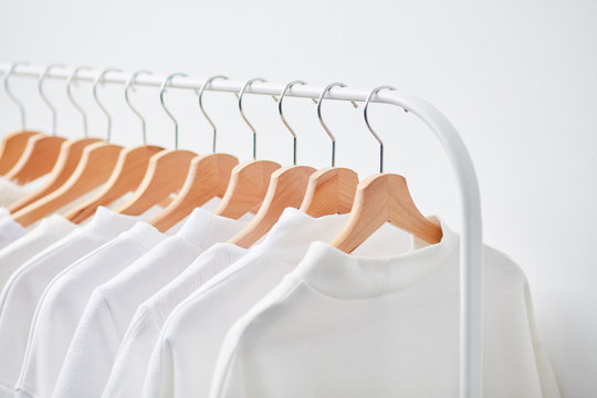 Rack of white clothes on hangers
