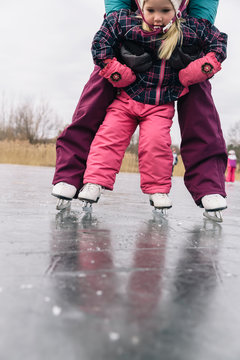 Family Lifestyle Winter Image of Child Learning to Skate