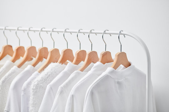 Row of hangers with white clothing
