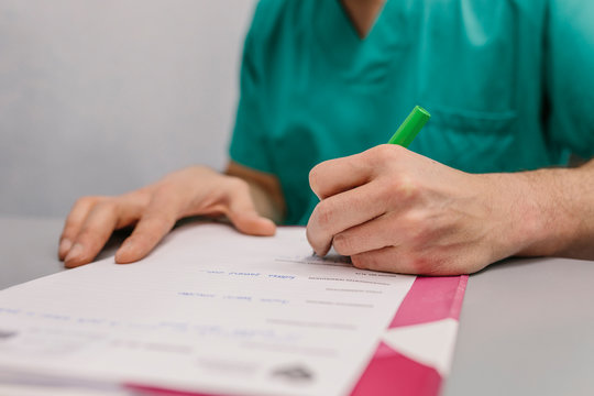 Surgeon filling a report