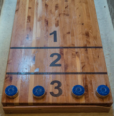 Wooden shuffleboard with blue discs