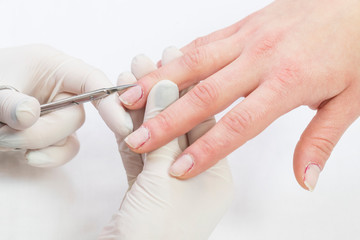 Female hand manicure procedure shot in closeup in a beauty salon.