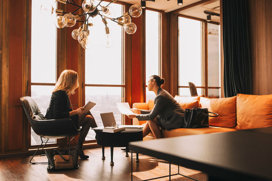 Legal colleagues discussing over documents in law office - Powered by Adobe