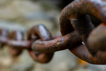 Detail of a big iron chain used to close the streets and avoid cars to get into the historic center of the ancient city of Paraty, Rio de Janeiro, world heritage in Brazil
