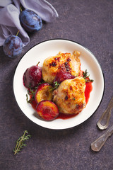 Baked chicken and plums in ginger, honey and red wine sauce with thyme. View from above, top view