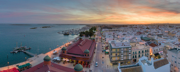 Naklejka premium Dusk aerial cityscape in Olhao, Algarve fishing village view of ancient neighbourhood and its traditional cubist architecture. Portugal.