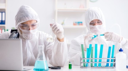 The two chemists working in the lab