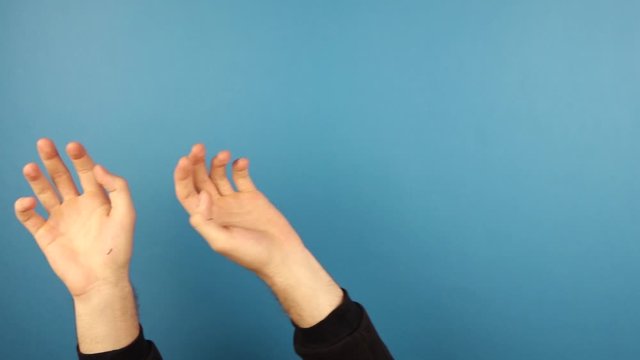 man hands waving, music rhythm gesture isolated over blue background in studio.