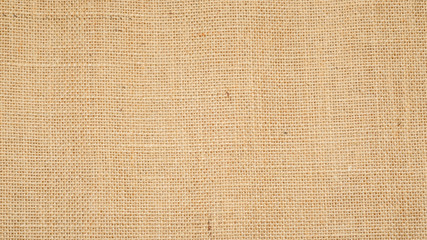 Hessian sackcloth burlap woven texture background  / cotton woven fabric background with flecks of varying colors of beige and brown. with copy space. office desk concept.