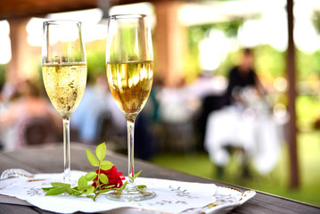 Two glasses of white wine ready for a wedding couple to toast.