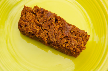 Piece of homemade pumpkin bread on green plate