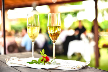 Glasses of cold champagne with unfocused background.