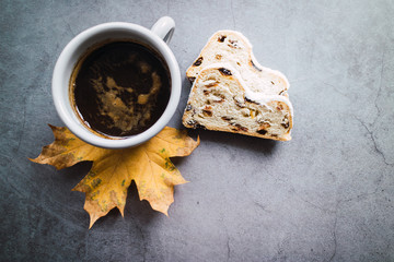 German stollen and mug of coffee on an autumn leaves.