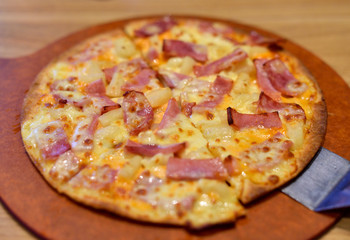 Hot pizza on wooden tray