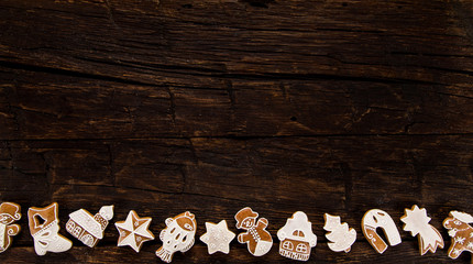 Christmas homemade gingerbread cookies on wooden table, top-down view.