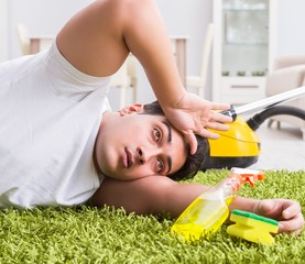 The young husband man cleaning floor at home
