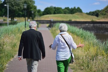 senior couple walking in the park