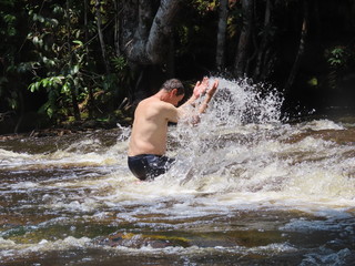 man in waterfall