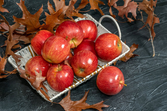 Red apples ranet in a basket on the black background.