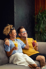 Obraz premium Young happy couple with fruit cocktails enjoying in their time together.