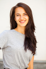 Happy brunette woman in gray t-shirt