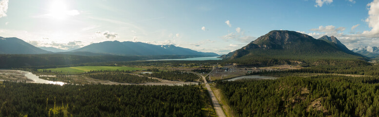 Fototapeta na wymiar Aerial Panoramic View of Small Town, Canal Flats, during a sunny and cloudy summer day. Located in the Kootenay, British Columbia, Canada.