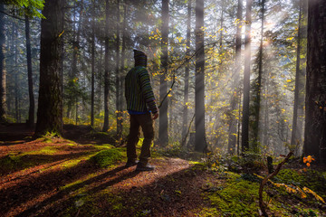 Obraz premium Adventure Man enjoying the Beautiful Canadian Nature View of the Forest during a foggy morning sunrise. Taken in Sloquet Hot Springs, Located North of Vancouver, British Columbia, Canada.