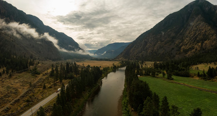 Aerial Panoramic View of a scenic Highway in the Valley surrounded by Canadian Mountain Landscape. Taken near Keremeos, British Columbia, Canada.