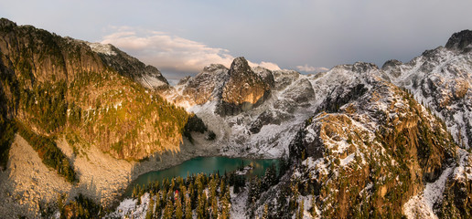 Obraz premium Aerial Panoramic View of Beautiful Canadian Mountain Landscape during a sunny sunset. Taken near Squamish, North of Vancouver, British Columbia, Canada.