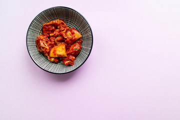 Kimchi on pink background. Korean cuisine. Top view.