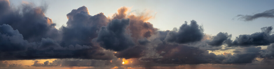 Fototapeta premium Dramatic Panoramic View of a cloudscape during a dark, rainy and colorful sunrise. Taken in Alaska, USA.