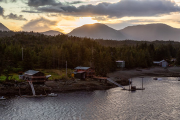 Beautiful Aerial View of homes near a historic town on the Ocean Coast during a dramatic stormy sunset. Taken in Ketchikan, Alaska, United States.