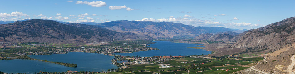 Fototapeta na wymiar Aerial Panoramic View of a Small Touristic Town during a beautiful sunny summer day. Taken in Osoyoos, British Columbia, Canada.