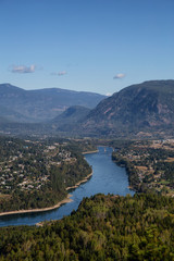 Obraz premium Aerial View of a small town, Castlegar, during a sunny summer day. Located in Central Kootenay, British Columbia, Canada.