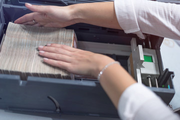 Bank employees sorting and counting money inside bank vault. Large amounts of money in the bank.